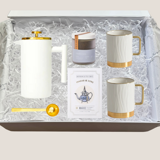 with Gold Trim French Press/ Tea Press, Two White Porcelain Mugs with Gold Trim and Gold Aluminum Non- Slip Base, Gold Tea Scoop, Choice of Charles Gray Or Green Gold Loose Leaf Tea,  Makabi & Sons Shortbread Cookies, Packaged in a Matte White Gift Box and Tied with a Ribbon Bow, Luxury Gift Box, Luxury Gift Reno, Gift Company Reno