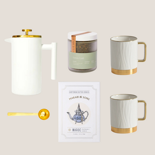 with Gold Trim French Press/ Tea Press, Two White Porcelain Mugs with Gold Trim and Gold Aluminum Non- Slip Base, Gold Tea Scoop, Choice of Charles Gray Or Green Gold Loose Leaf Tea,  Makabi & Sons Shortbread Cookies, Packaged in a Matte White Gift Box and Tied with a Ribbon Bow, Luxury Gift Box, Luxury Gift Reno, Gift Company Reno